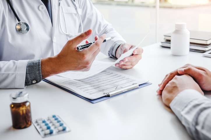 doctor looking over blood results for patient